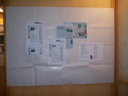 Newspaper articles about the event are displayed